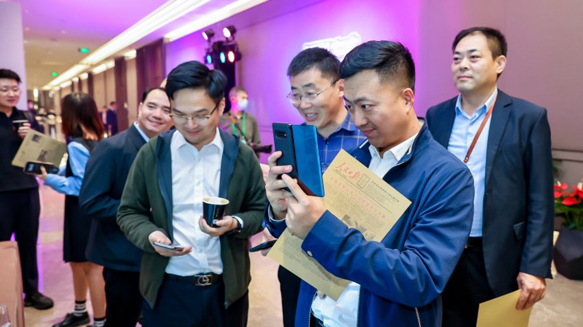 人民網(wǎng)研發(fā)推出的《人民日?qǐng)?bào)》生日?qǐng)?bào)吸引嘉賓體驗(yàn)。主辦方供圖